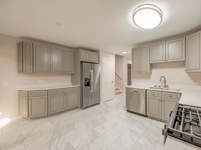 a kitchen with cabinets and stainless steel appliances