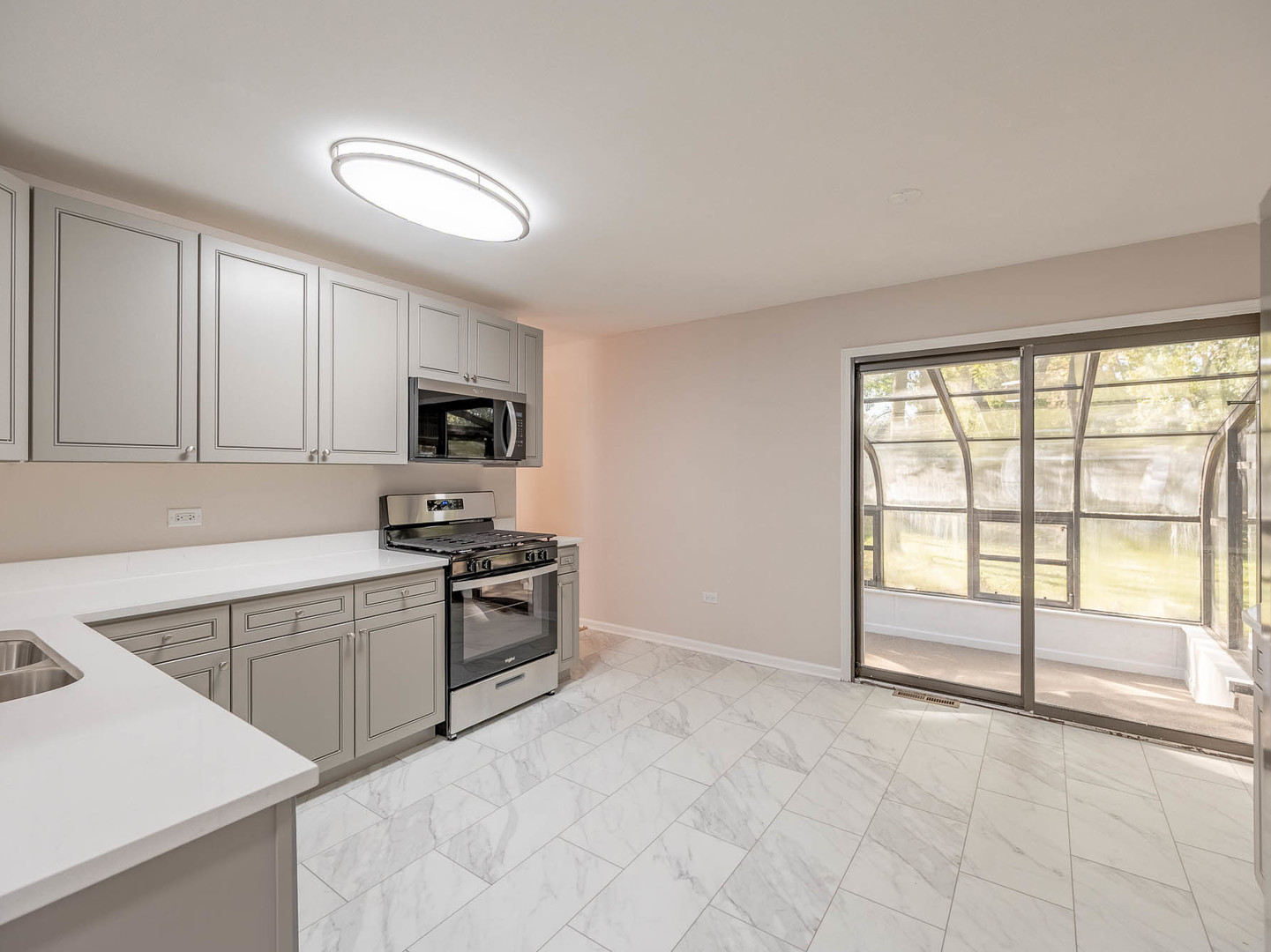 7104 Blackburn Avenue Downers Grove, IL 60516 - Photo 6 of 17 a kitchen with granite countertop a stove a sink and a refrigerator