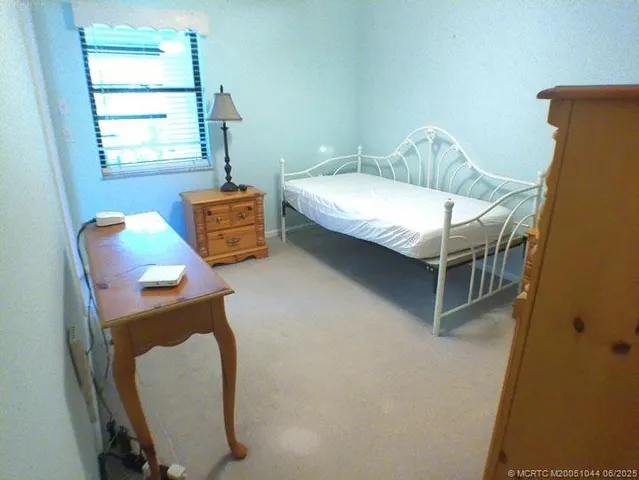 a bedroom with a bed and a chair