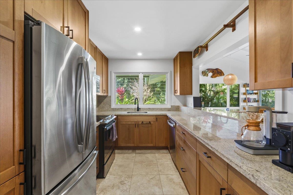 20 Hui Road East, Unit 37 Lahaina, HI 96761 - Photo 11 of 39 a kitchen with stainless steel appliances granite countertop a refrigerator and a sink