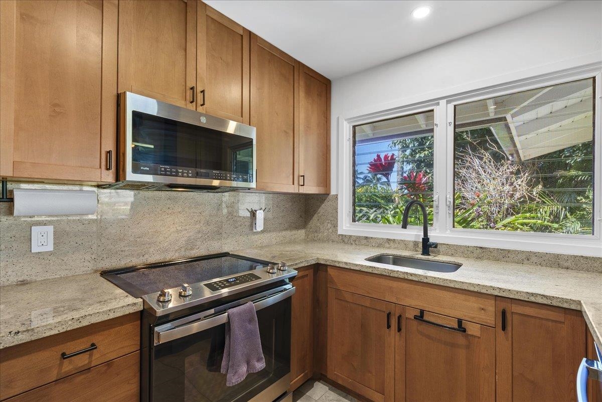 20 Hui Road East, Unit 37 Lahaina, HI 96761 - Photo 12 of 39 a kitchen with stainless steel appliances a stove sink and microwave