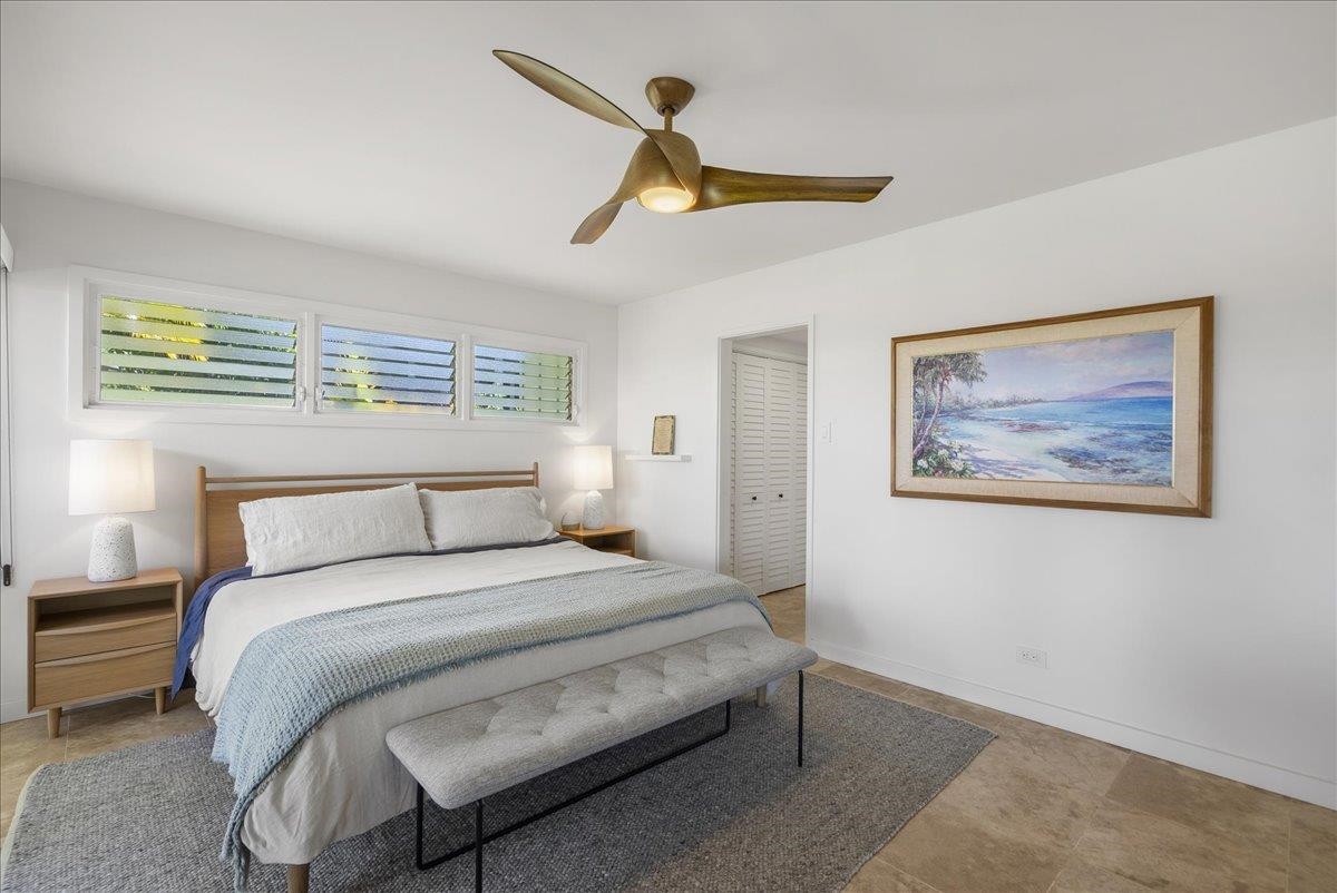 20 Hui Road East, Unit 37 Lahaina, HI 96761 - Photo 22 of 39 a bedroom with a bed and a painting on the wall