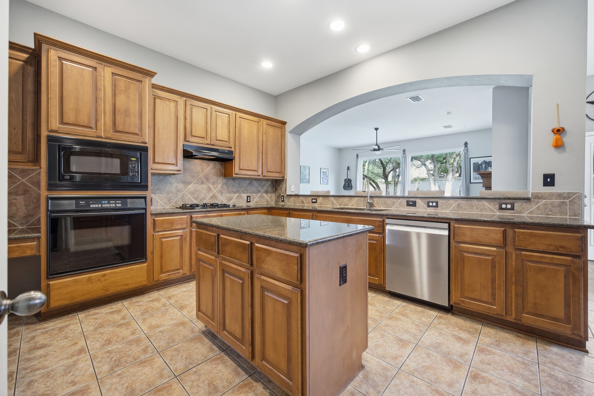 2204 Rio Mesa Drive Austin, TX 78732 - Photo 18 of 40 The kitchen features a built-in oven and microwave, a gas stovetop, and stainless steel appliances