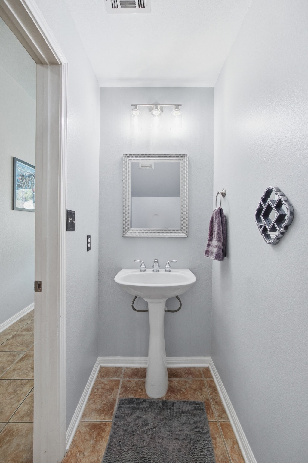 2204 Rio Mesa Drive Austin, TX 78732 - Photo 20 of 40 This bathroom features a white pedestal sink with a mirror above, set against light grey walls