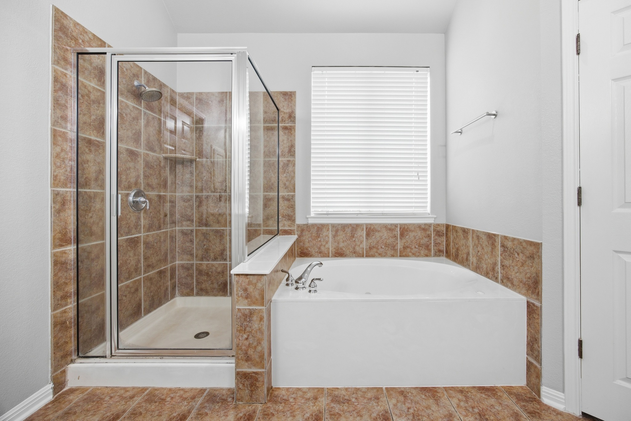 2204 Rio Mesa Drive Austin, TX 78732 - Photo 24 of 40 Bathroom featuring a tiled shower with a glass enclosure, a built-in bathtub with tiled surround, and a window with blinds
