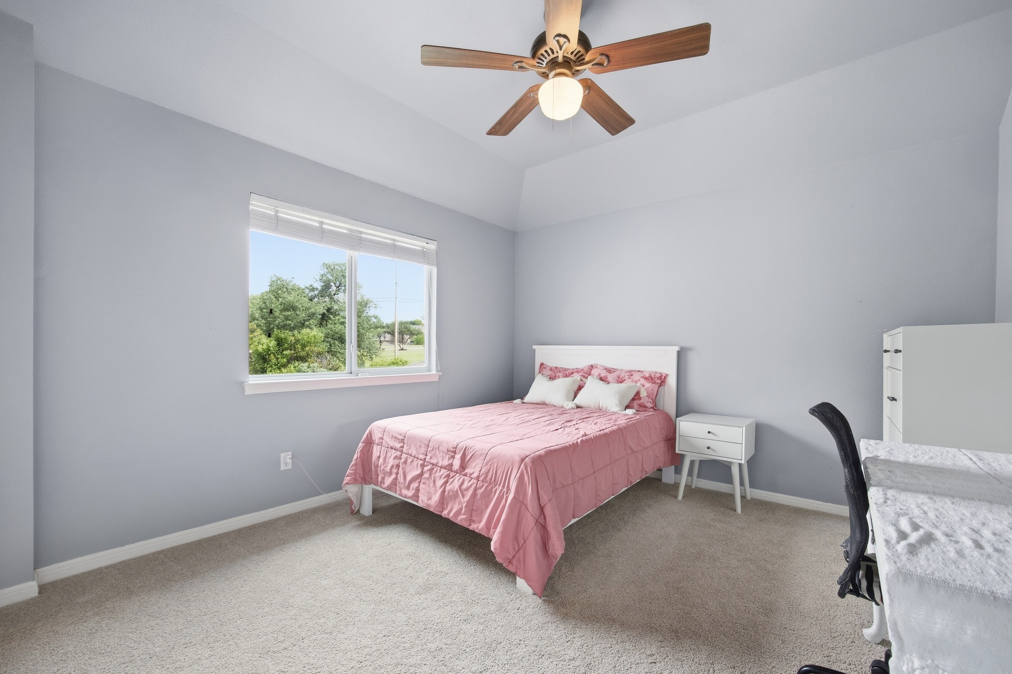 2204 Rio Mesa Drive Austin, TX 78732 - Photo 28 of 40 This room features light-colored walls and carpeting, a window with a view of greenery, and a ceiling fan with light fixture