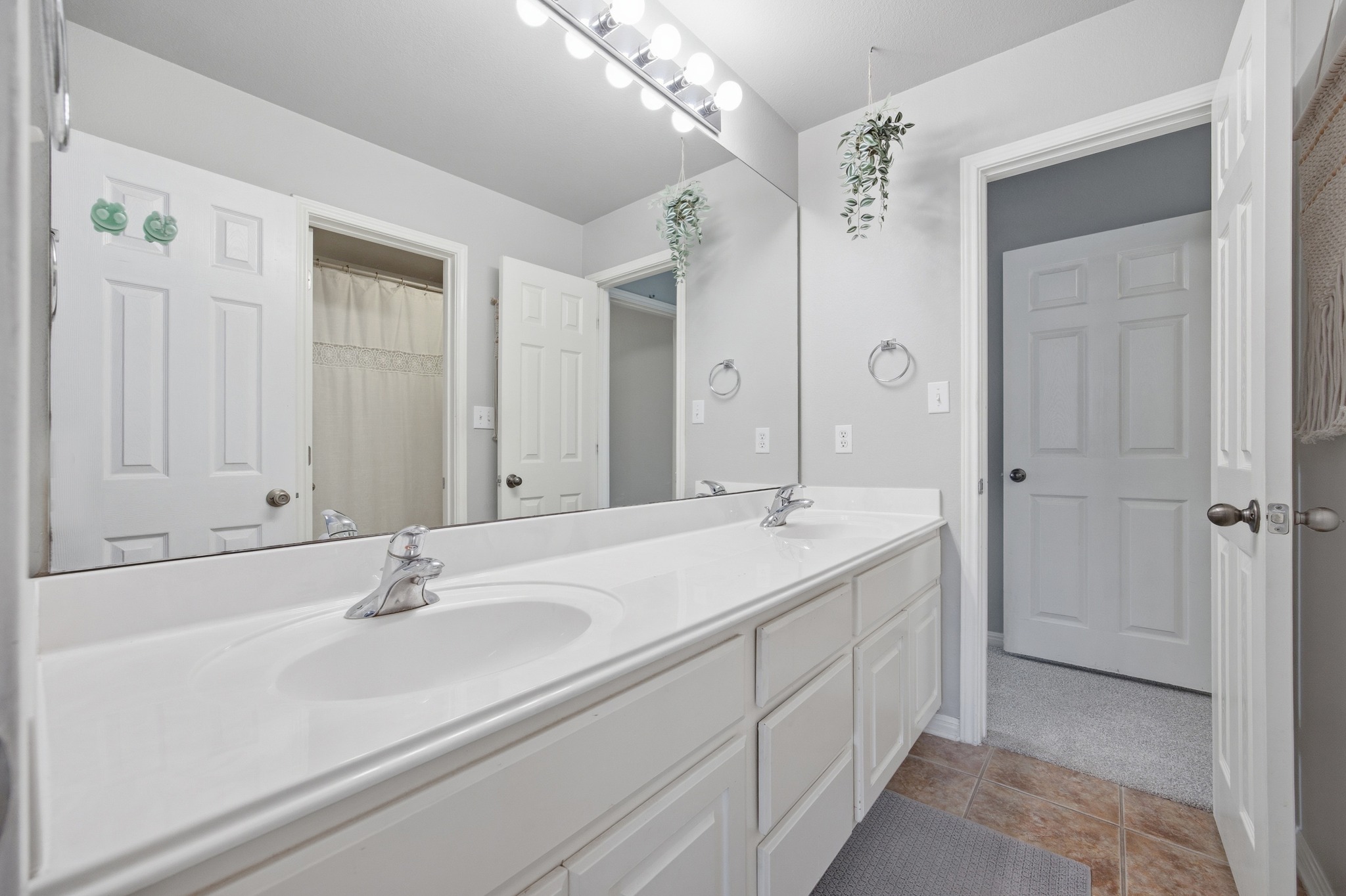2204 Rio Mesa Drive Austin, TX 78732 - Photo 31 of 40 Bathroom featuring a double vanity with white countertops, a large mirror, and tiled flooring
