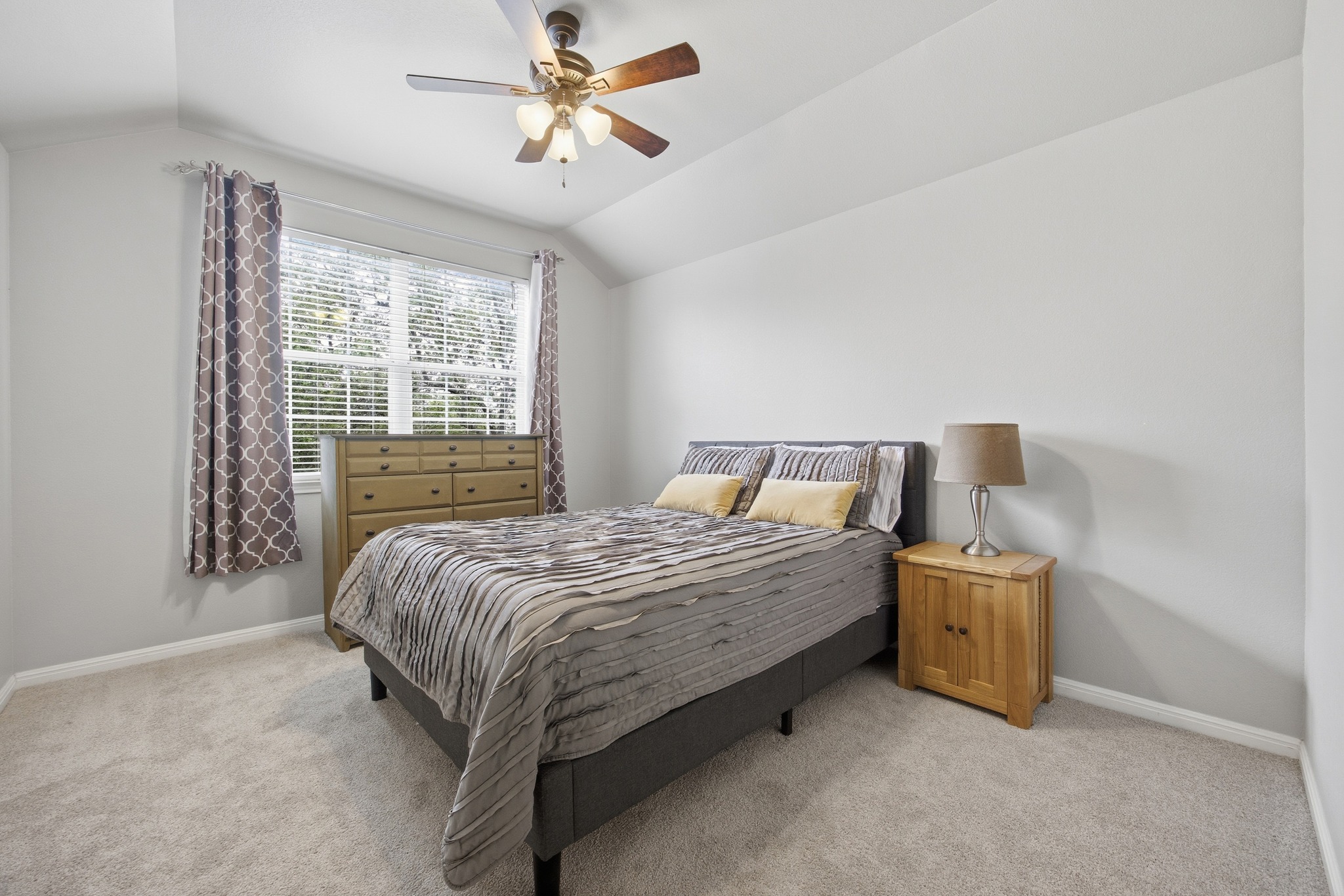 2204 Rio Mesa Drive Austin, TX 78732 - Photo 32 of 40 The room features carpeted flooring, a window with blinds, and a ceiling fan