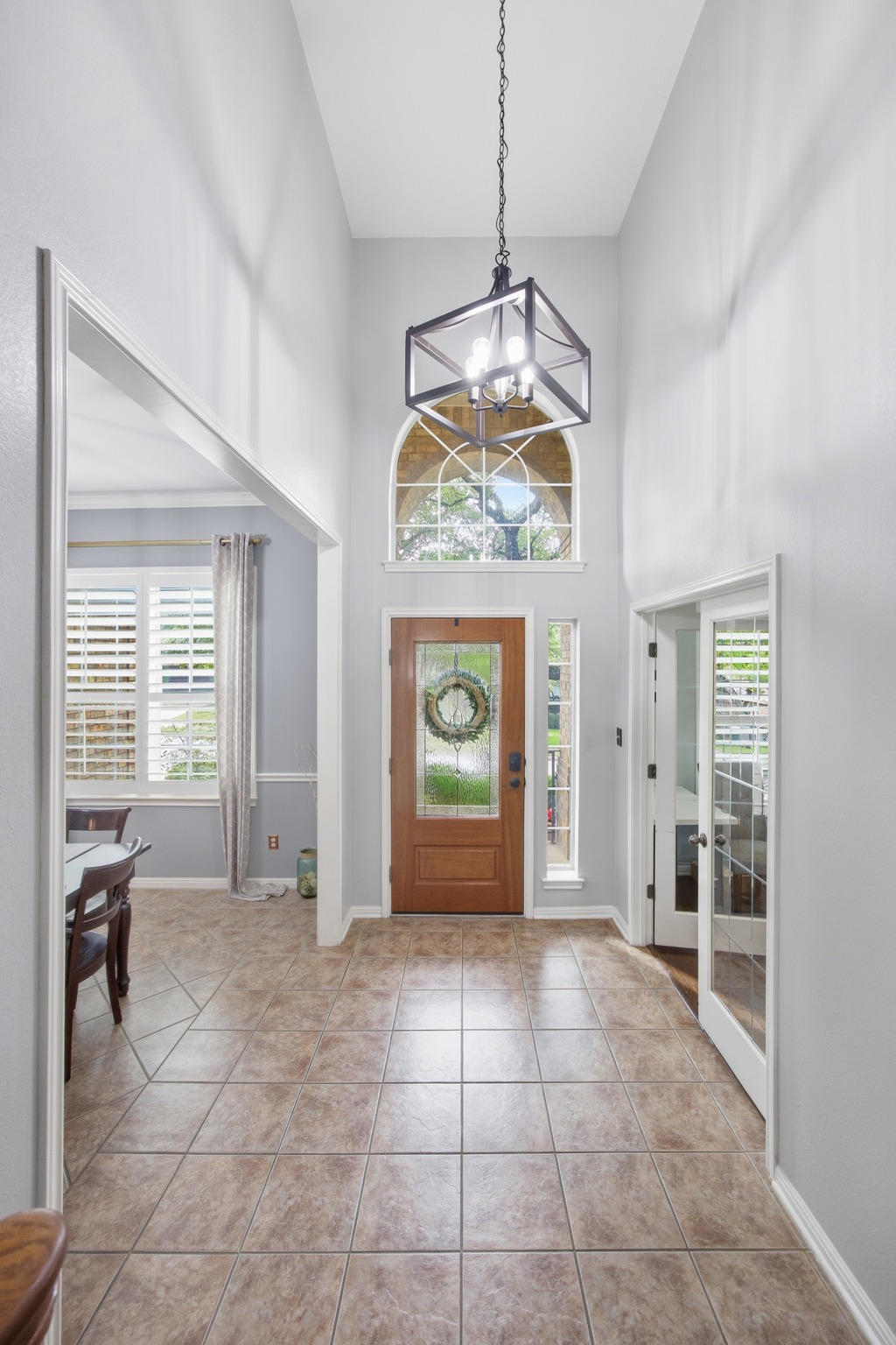 2204 Rio Mesa Drive Austin, TX 78732 - Photo 4 of 40 Entryway featuring high ceilings, a decorative chandelier, and tile flooring