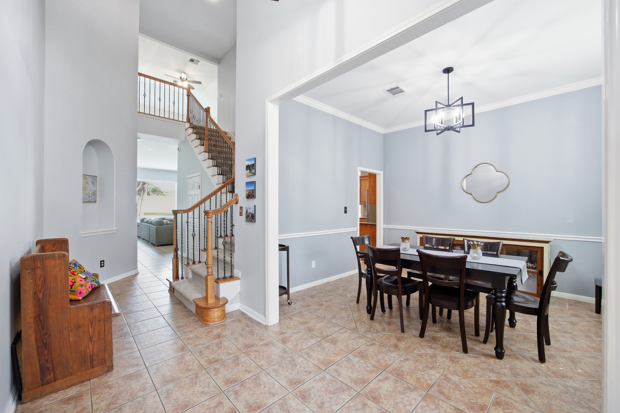 2204 Rio Mesa Drive Austin, TX 78732 - Photo 6 of 40 The property features an entryway with tiled flooring and a staircase with wooden handrails and wrought iron balusters