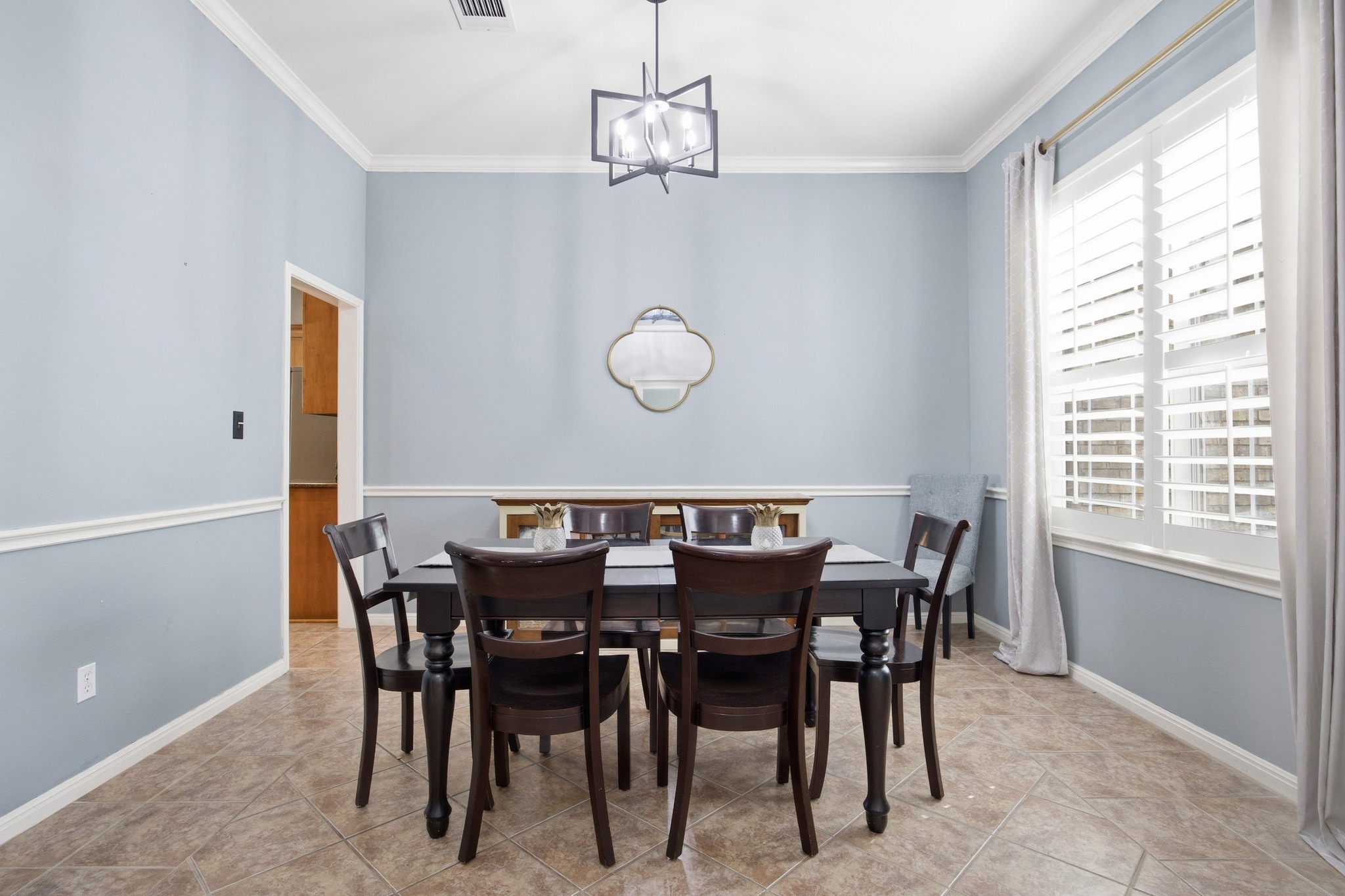 2204 Rio Mesa Drive Austin, TX 78732 - Photo 7 of 40 The property features light blue walls, white crown molding, and a modern ceiling light fixture