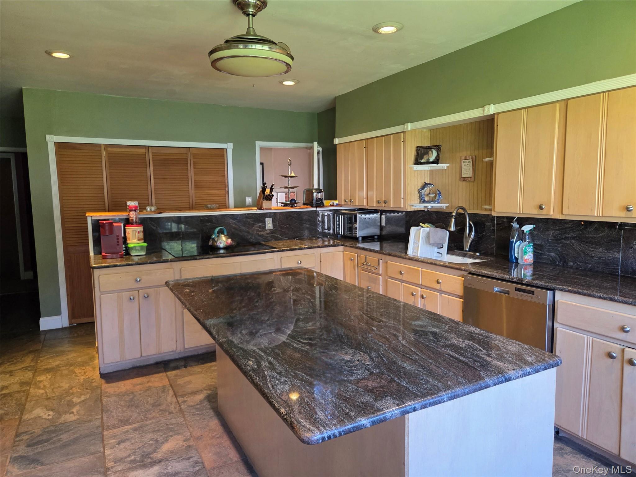 125 Zimmerman Road Loch Sheldrake, NY 12759 - Photo 5 of 43 a kitchen with stainless steel appliances granite countertop a sink a counter top space and cabinets