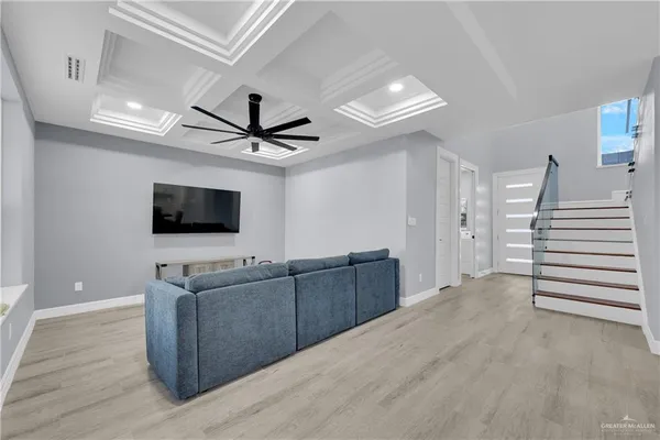 a view of a livingroom with wooden floor and furniture