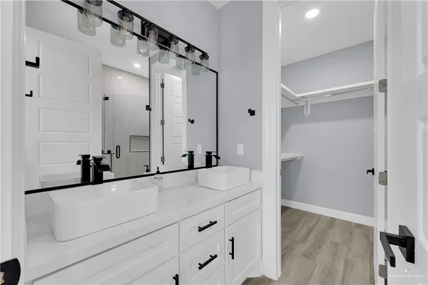 a bathroom with a tub sink and mirror