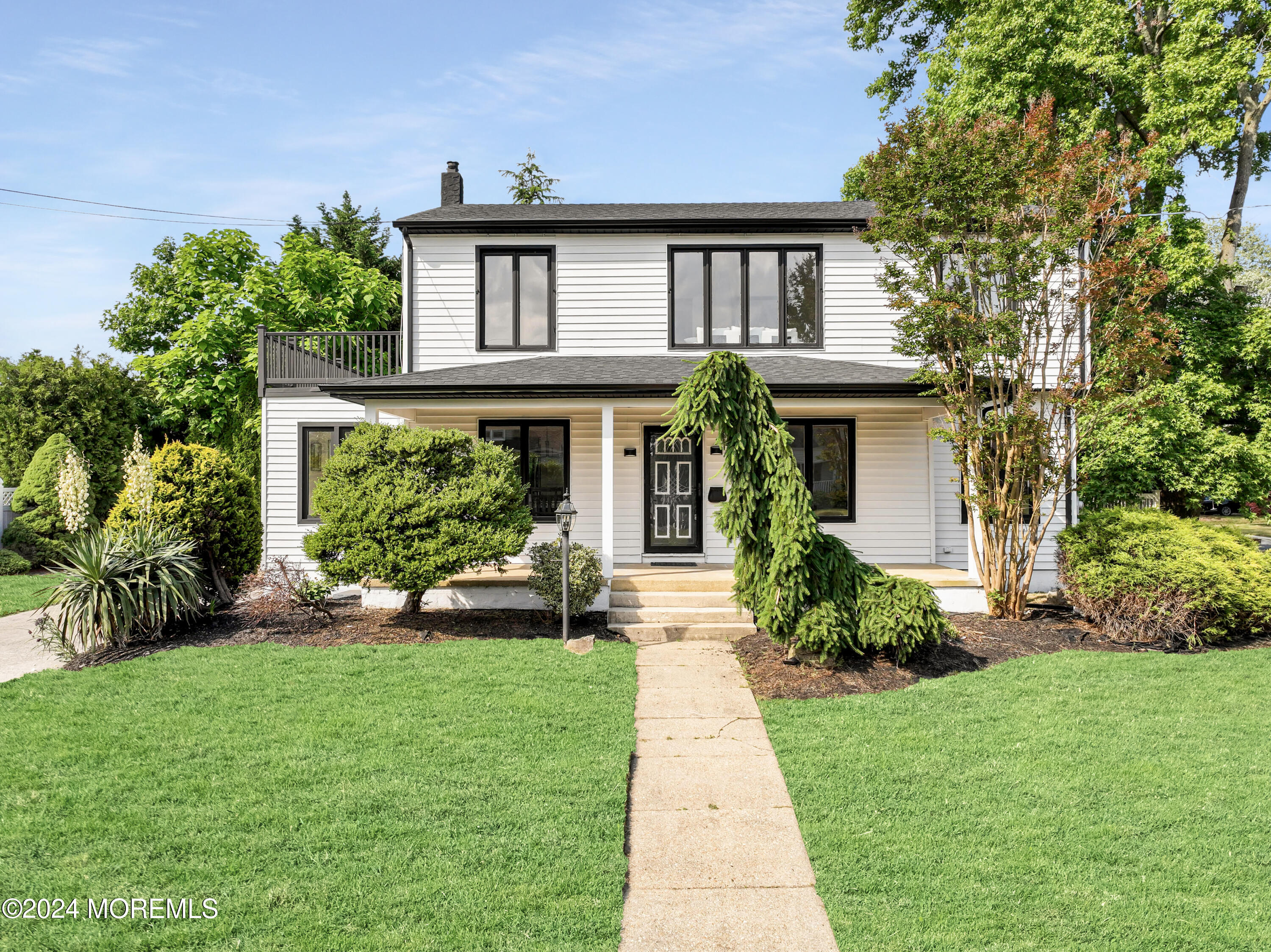 90 Riverview Avenue Neptune, NJ 07753 - Photo 1 of 31 a front view of a house with a yard and potted plants