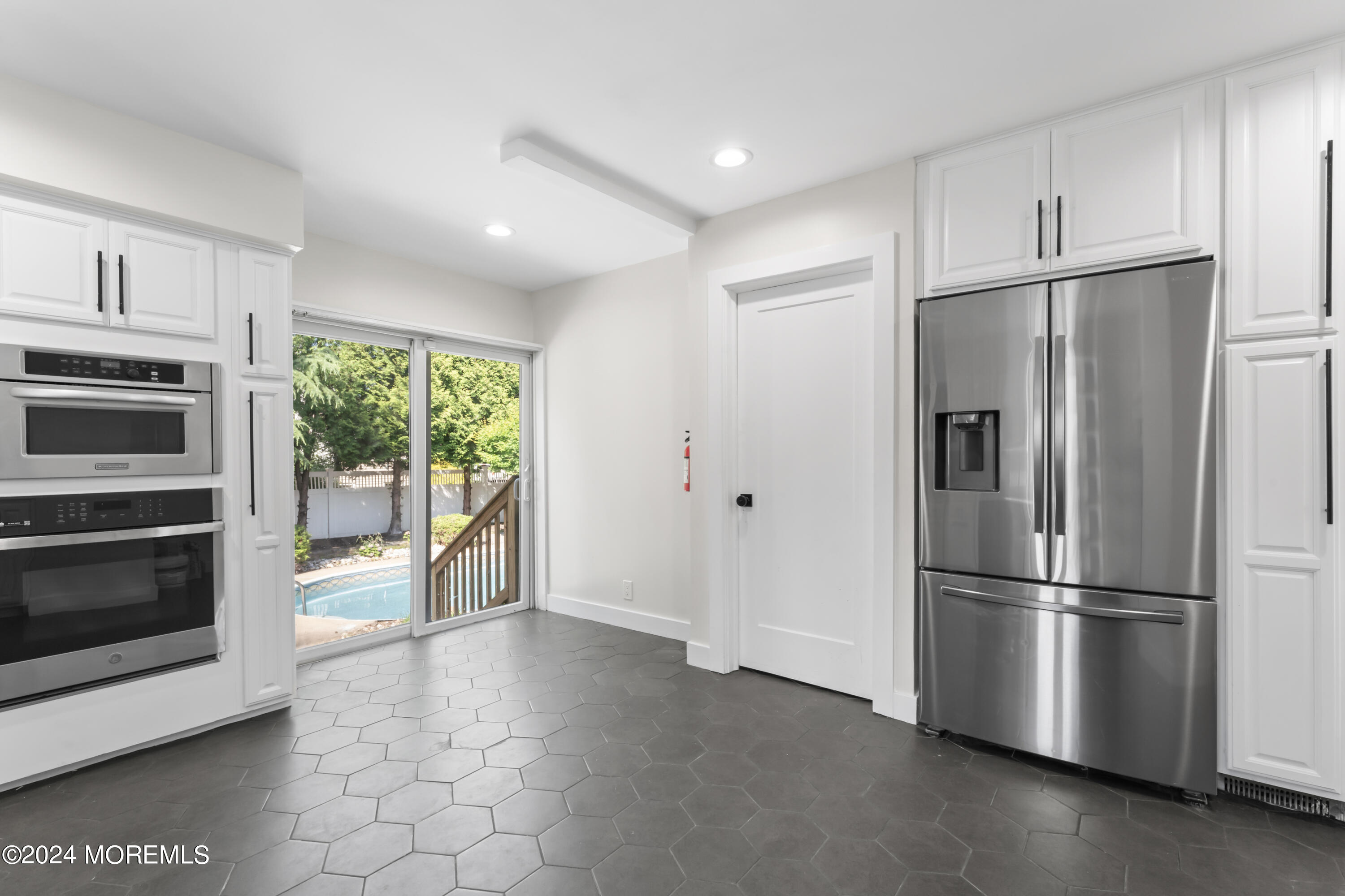 90 Riverview Avenue Neptune, NJ 07753 - Photo 11 of 31 a kitchen with stainless steel appliances a refrigerator and a stove top oven