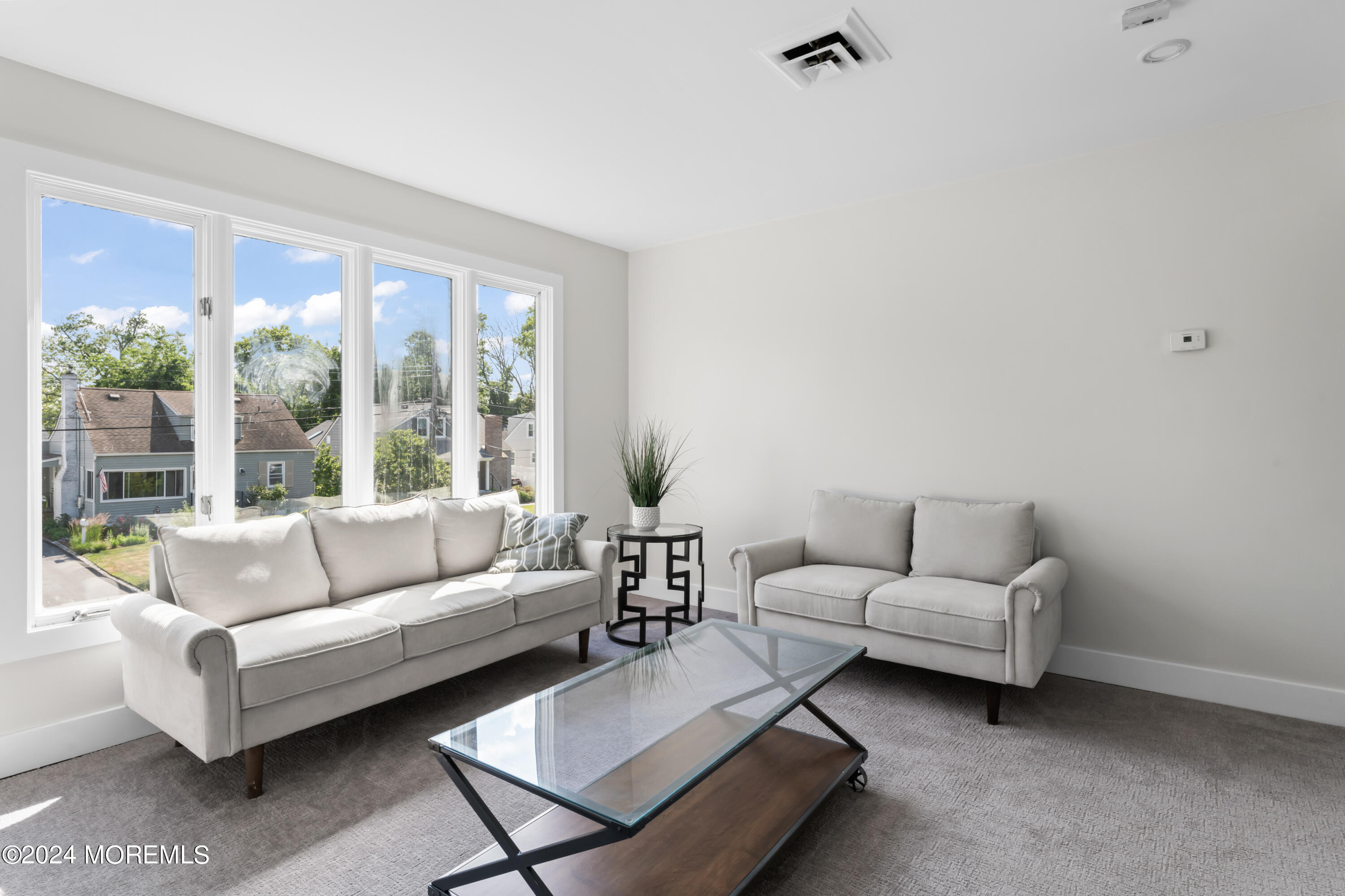 90 Riverview Avenue Neptune, NJ 07753 - Photo 19 of 31 a living room with furniture and a large window