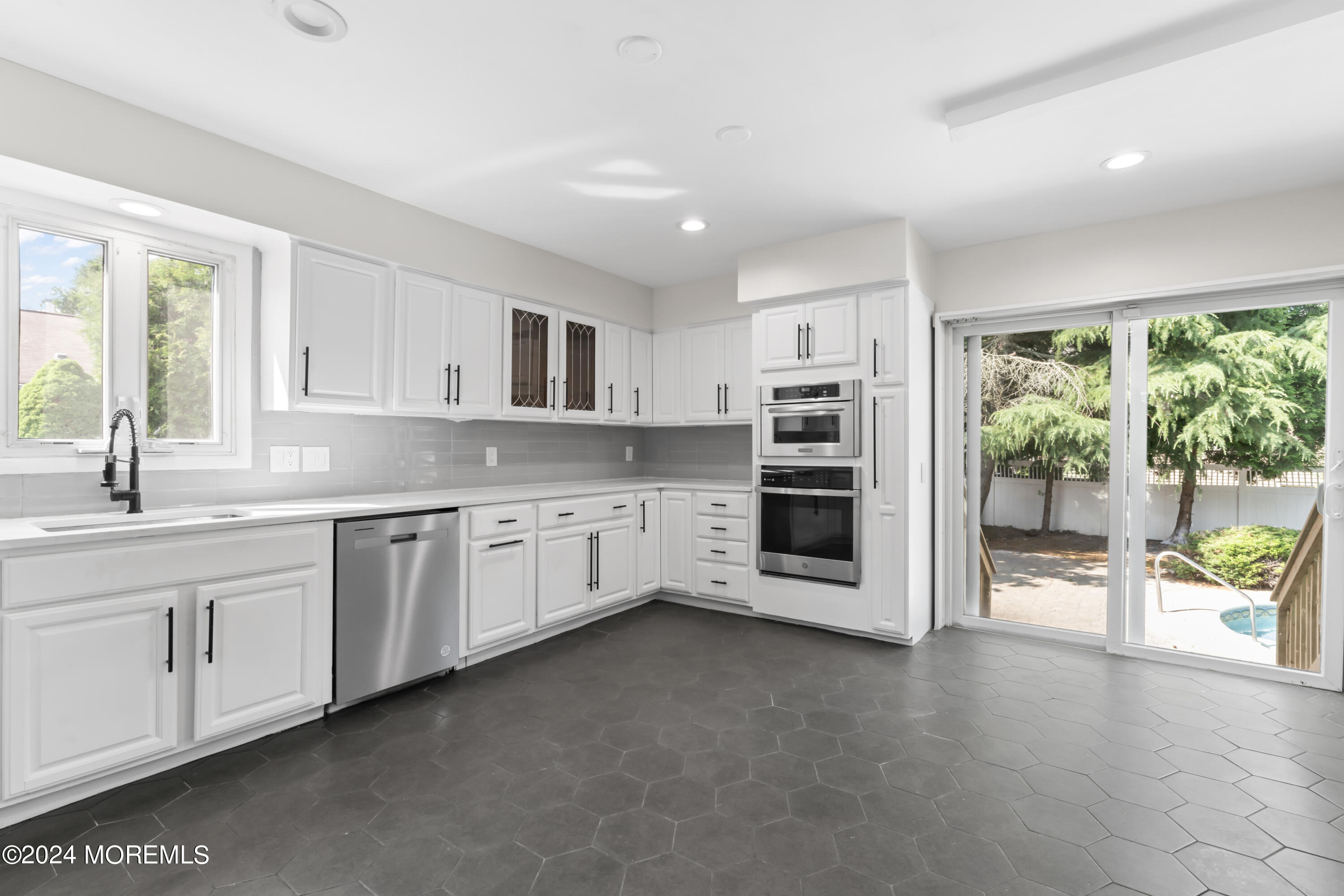 90 Riverview Avenue Neptune, NJ 07753 - Photo 9 of 31 a kitchen with stainless steel appliances granite countertop a stove sink and cabinets