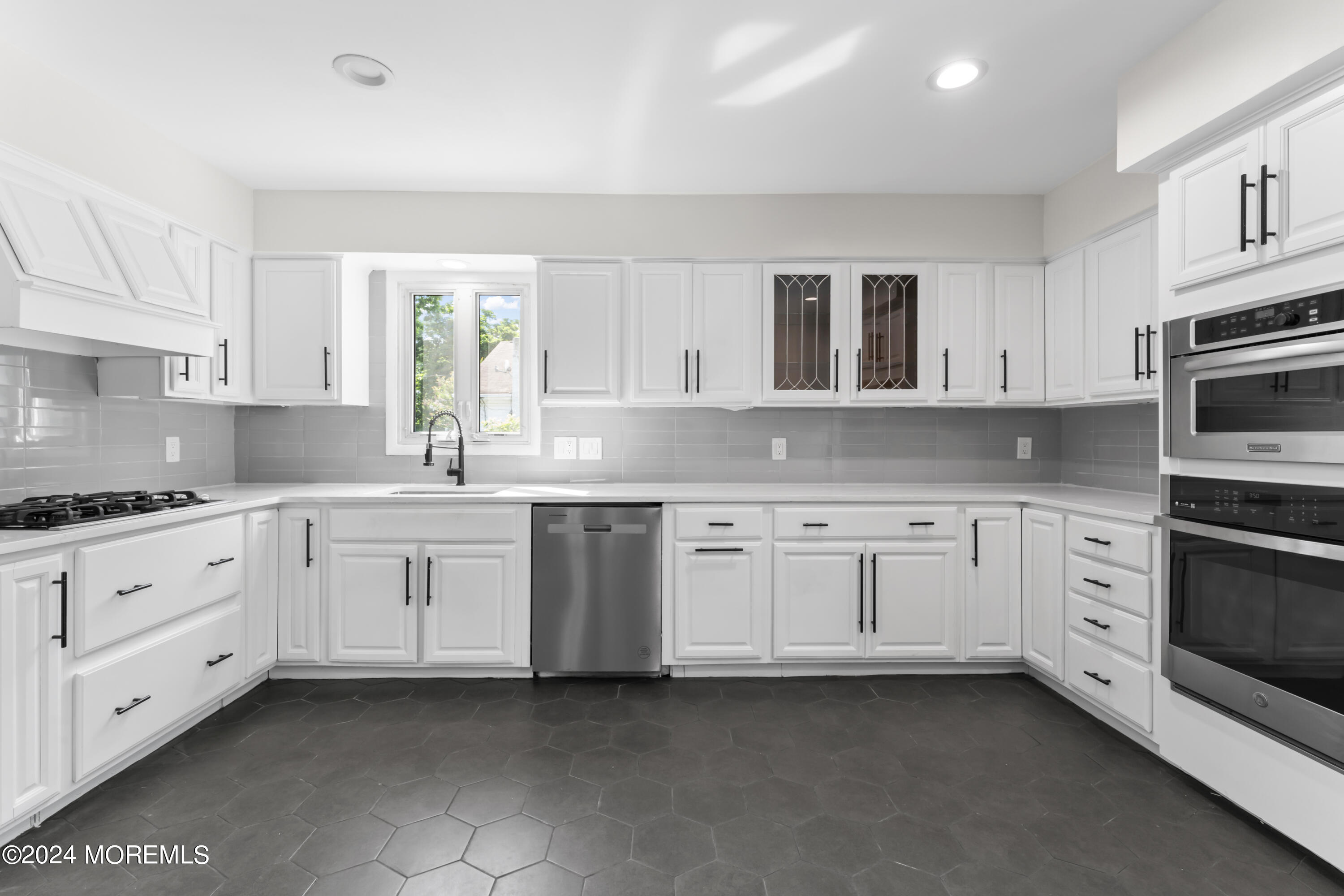 90 Riverview Avenue Neptune, NJ 07753 - Photo 10 of 31 a kitchen with granite countertop white cabinets white stainless steel appliances with a sink and dishwasher