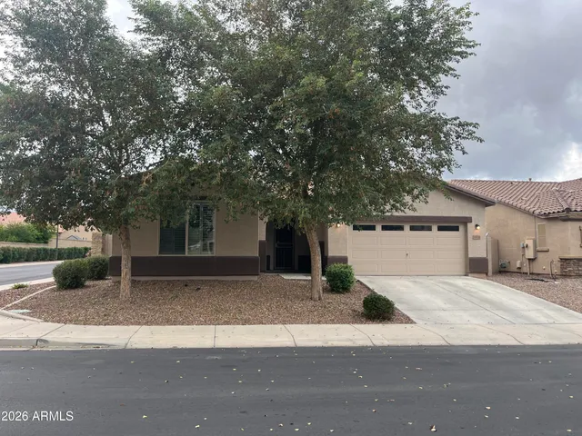 a view of a house with a yard and garage