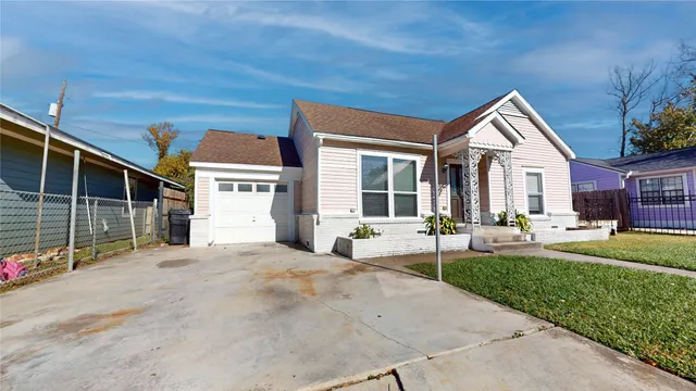 a front view of a house with potted plants