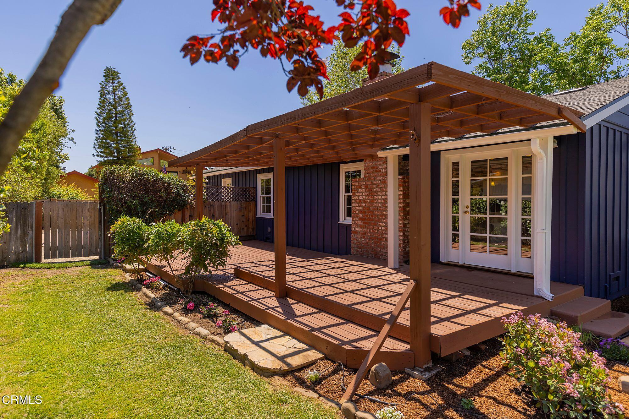 1010 Fairview Road Ojai, CA 93023 - Photo 3 of 24 a backyard of a house with wooden fence and large tree