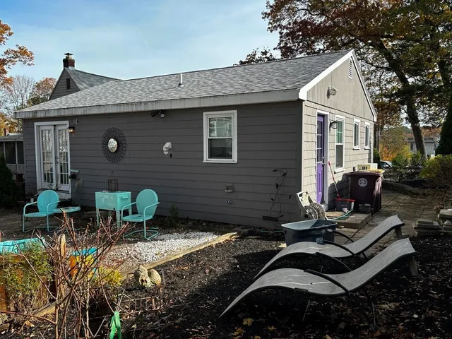a view of backyard of house with outdoor seating