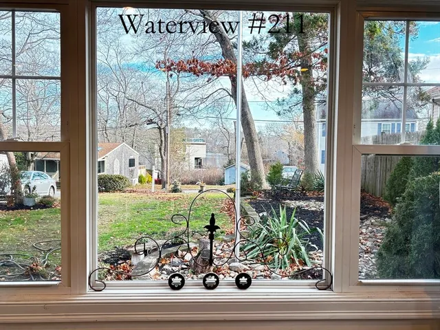 a view of a porch with a potted plant and a window