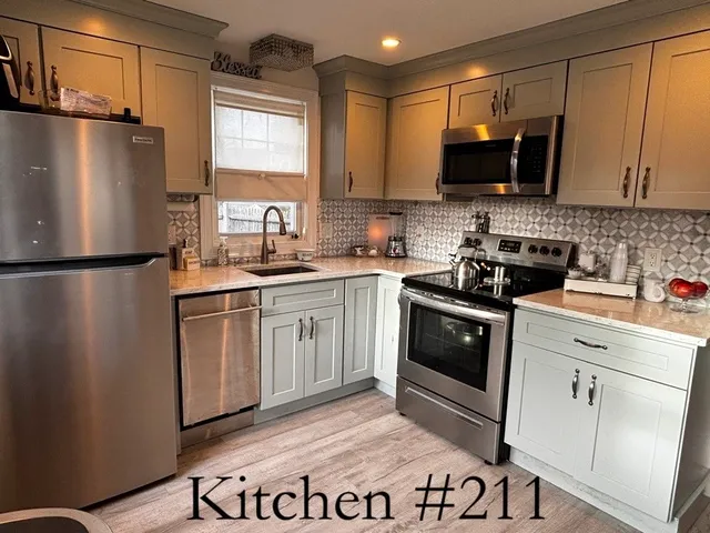 a kitchen with a sink stove and refrigerator