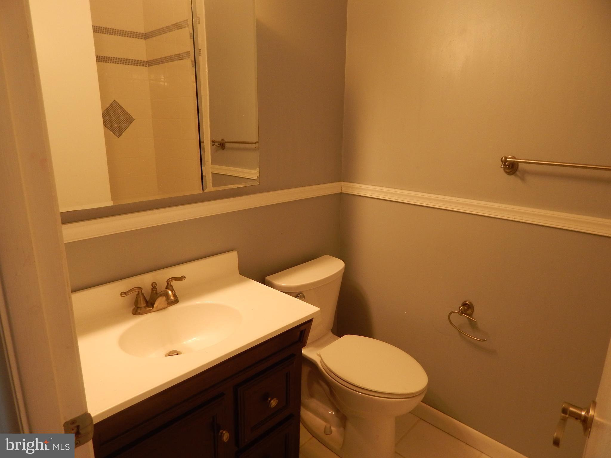 90 Haverhill Road Joppa, MD 21085 - Photo 22 of 31 a bathroom with a sink a toilet and shower curtain