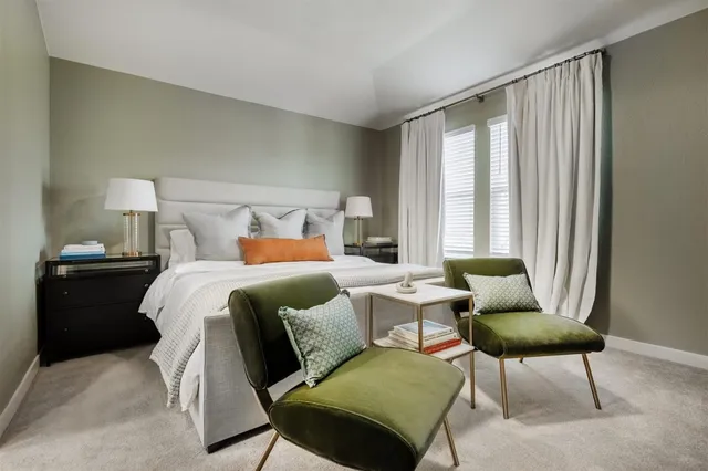 a bedroom with a bed and a chair