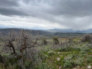 144 West Bear Tooth Ridge Coalville, UT 84017 - Photo 6 of 19 Expansive natural landscape featuring rolling hills, varied vegetation, and distant mountain ranges with snow-capped peaks
