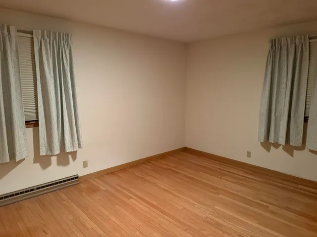 an empty room with wooden floor