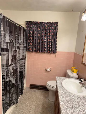 a bathroom with a sink toilet and shower