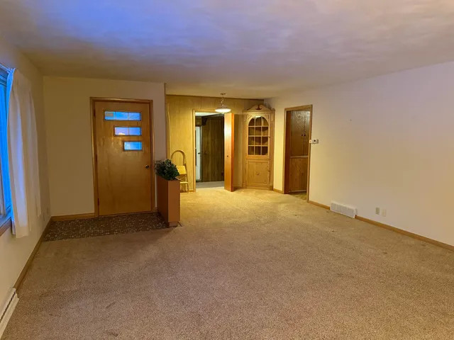 a view of a room with furniture and wooden floor