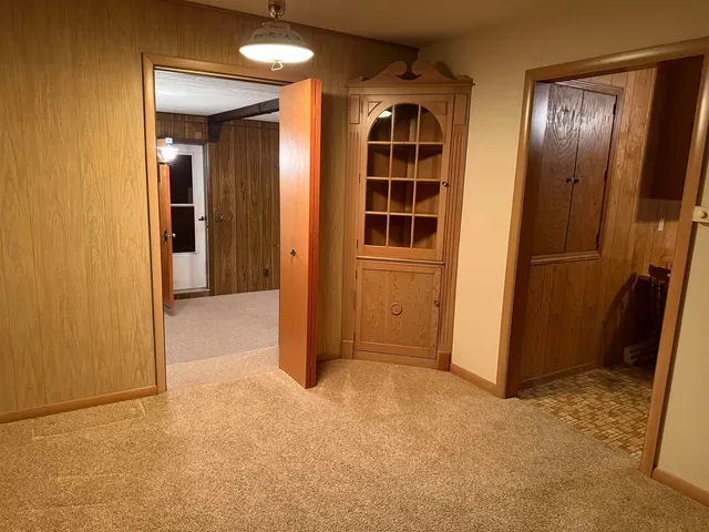 an empty room with closet and windows