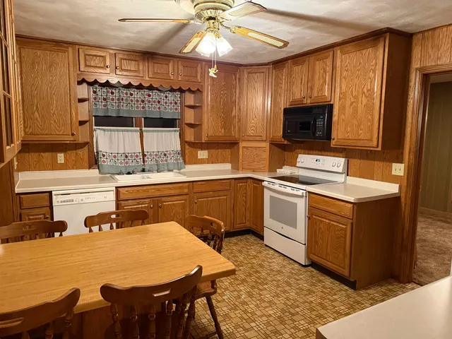 a kitchen with a table chairs stove and microwave