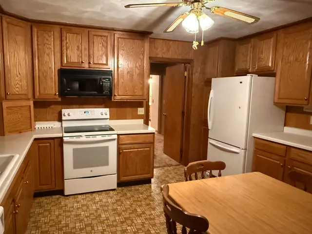 a kitchen with a refrigerator stove and microwave