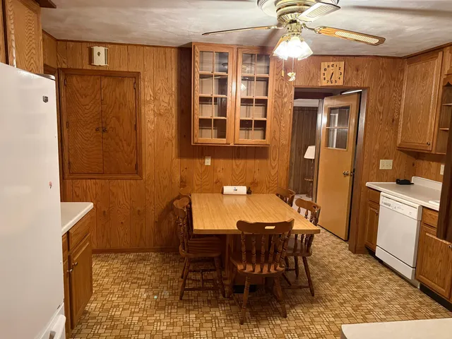 a view of a dining room with furniture and a chandelier
