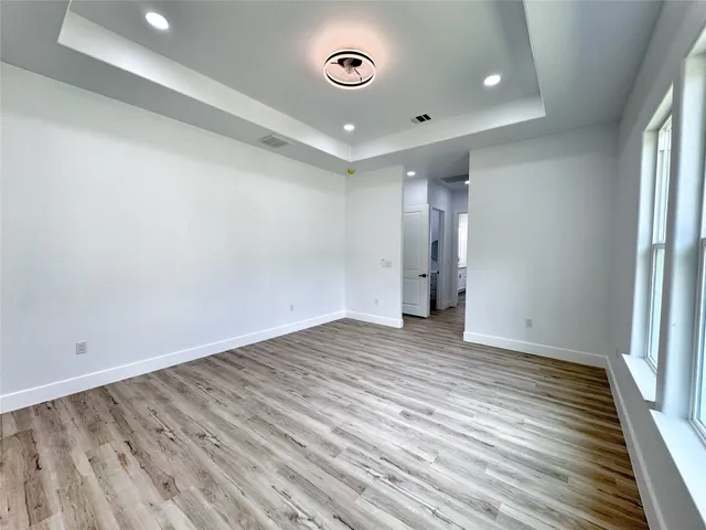 a view of a room with wooden floor