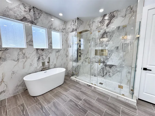 a bathroom with a bathtub and shower