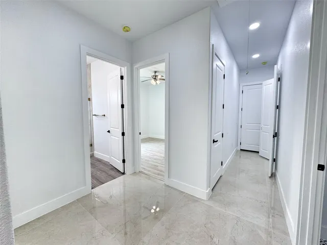 an empty room with closet and a bathroom