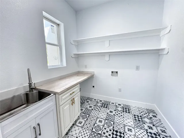 a kitchen with a sink and cabinets