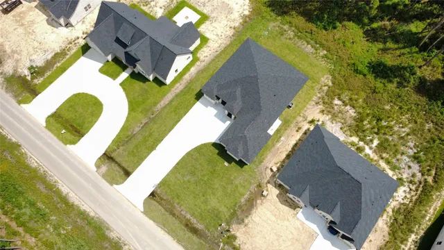 an aerial view of a house with a swimming pool