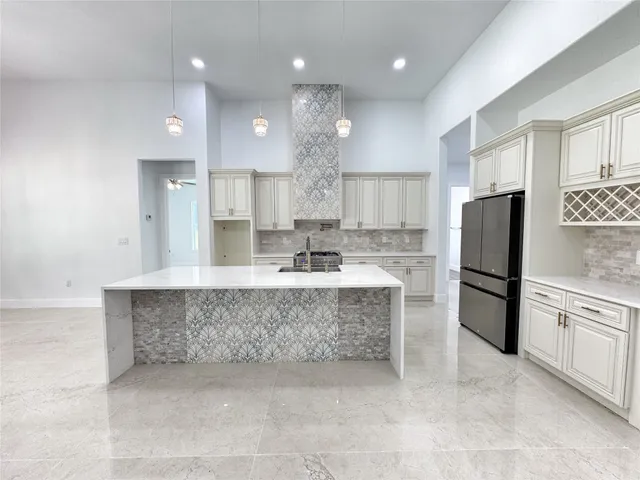 a large kitchen with kitchen island a sink stainless steel appliances and cabinets