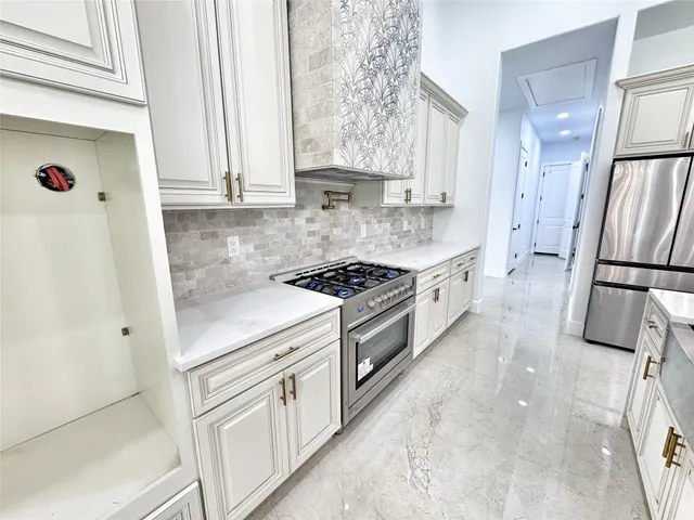 a kitchen with white cabinets and white appliances