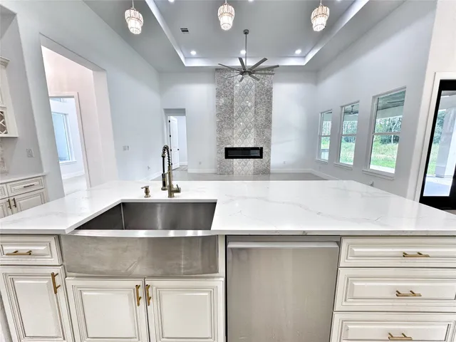 a kitchen with a sink and chandelier