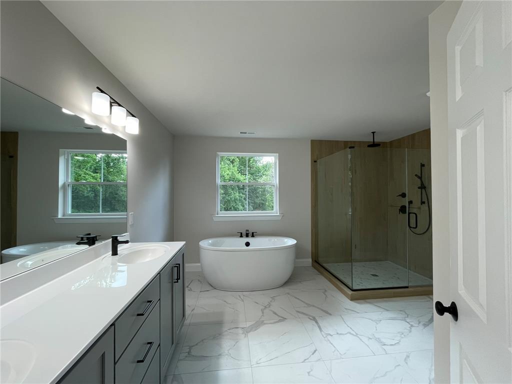 5043 Chapmans Road Orefield, PA 18069 - Photo 21 of 30 Indulge in a luxurious primary bathroom featuring a freestanding soaking tub and an oversized walk-in shower.