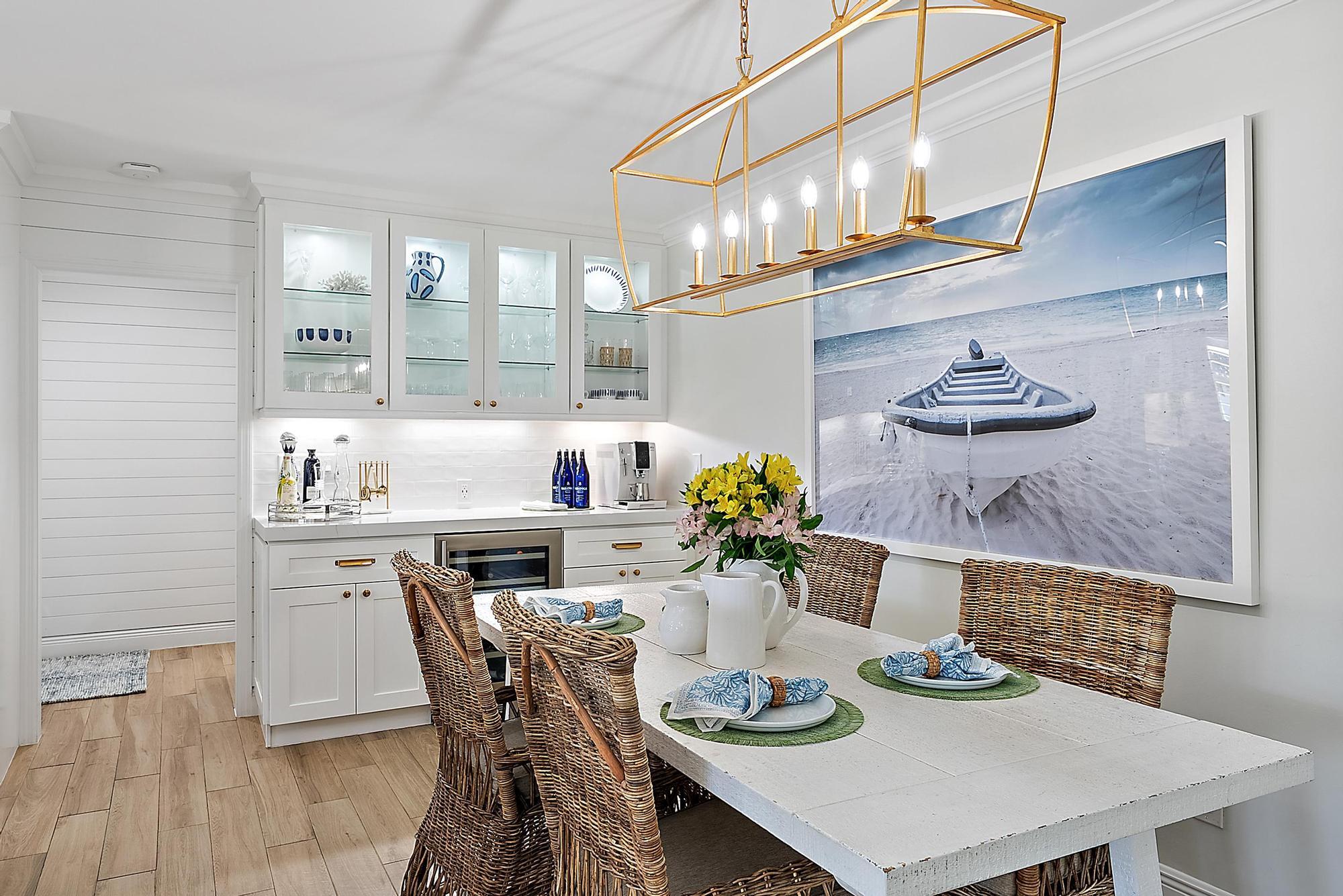 4967 Bimini Road Tequesta, FL 33469 - Photo 11 of 36 a kitchen with a dining table and chairs