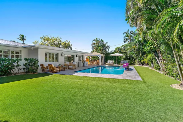 a view of an house with swimming pool and porch